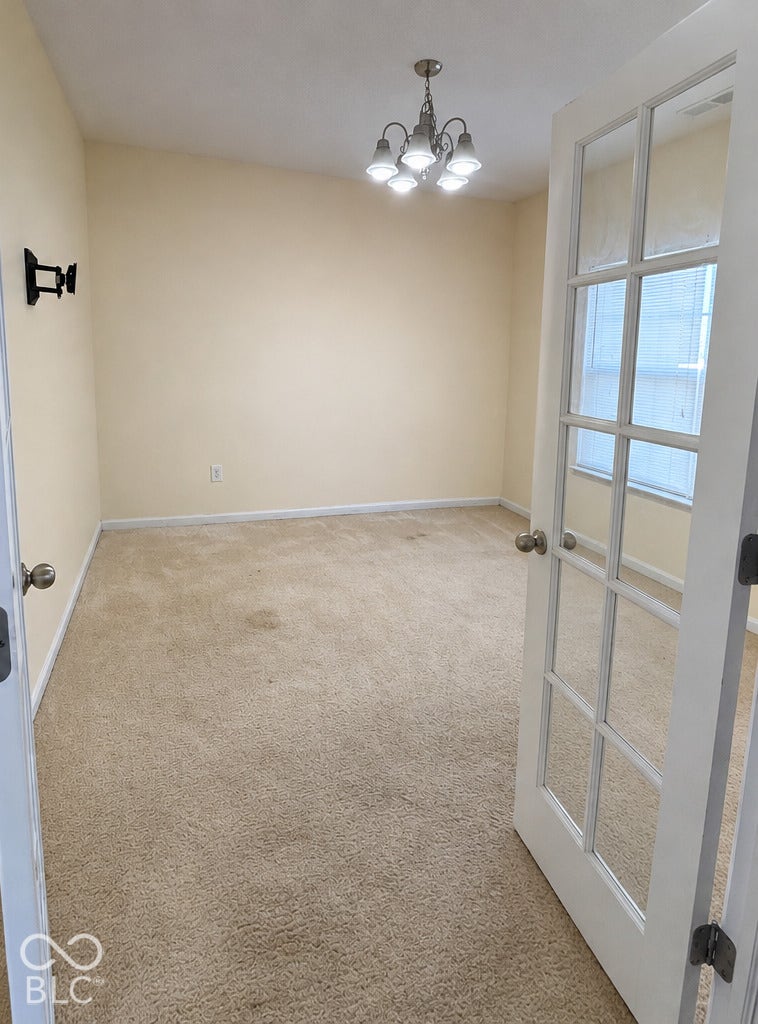 4348 Big Leaf Lane, Indianapolis, IN 46239 French Doors lead to 1st room by entrance, chandelier and natural sunlight illuminate the room