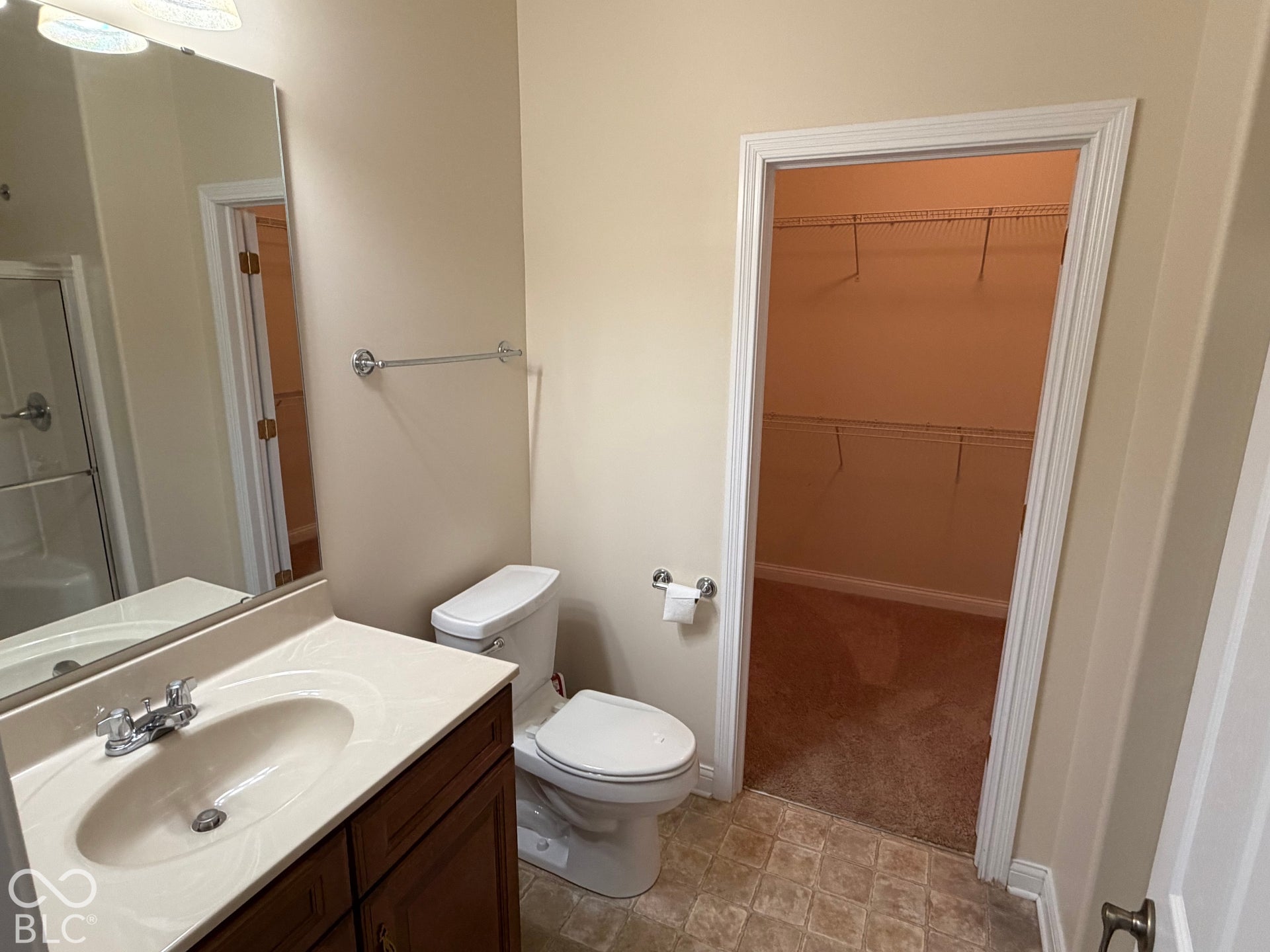 Vanity with integrated sink, chrome faucet, and cabinet storage