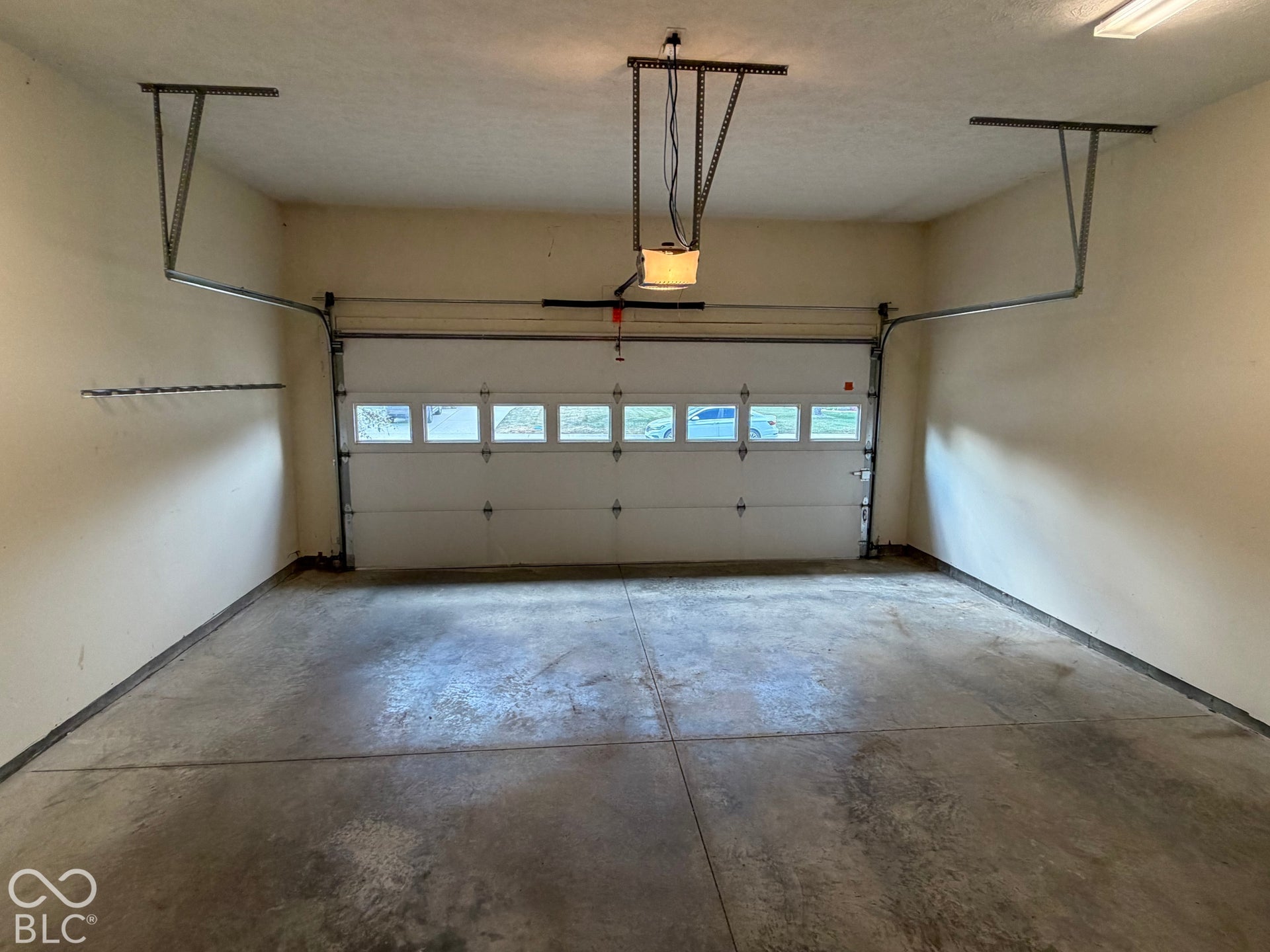 Attached garage with a sectional overhead door and translucent panel inserts