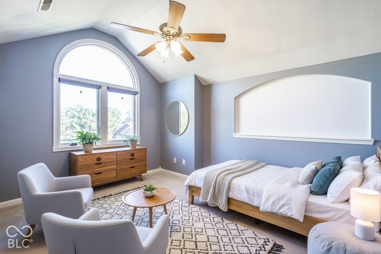 Virtually Altered - Bedroom 4 with arched window with upper transom, vaulted ceiling, ceiling fan. Could be used as home-office or bonus room. Virtually staged.