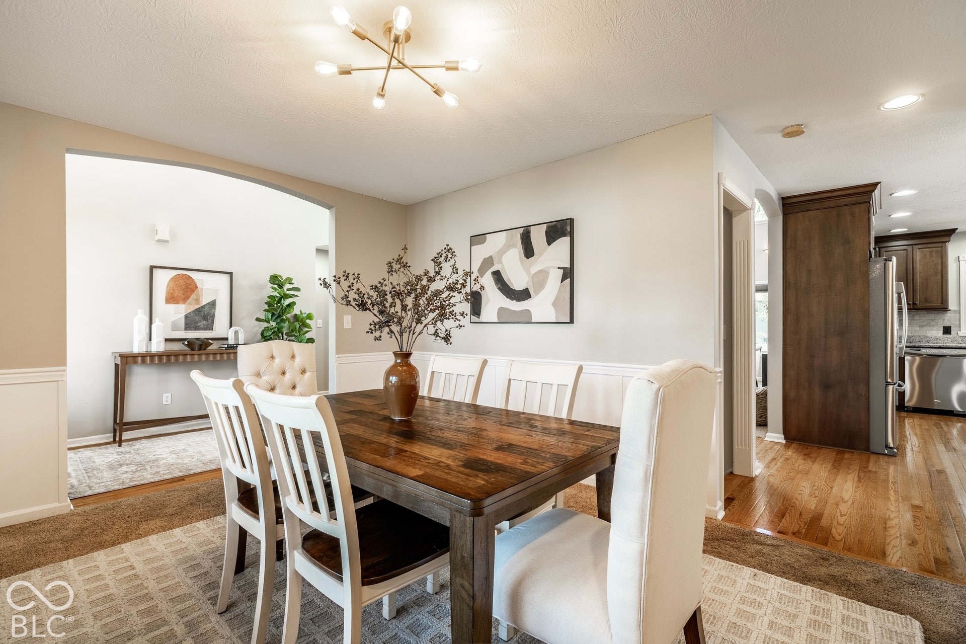 Dining room off entry with wainscoting and an arched entryway