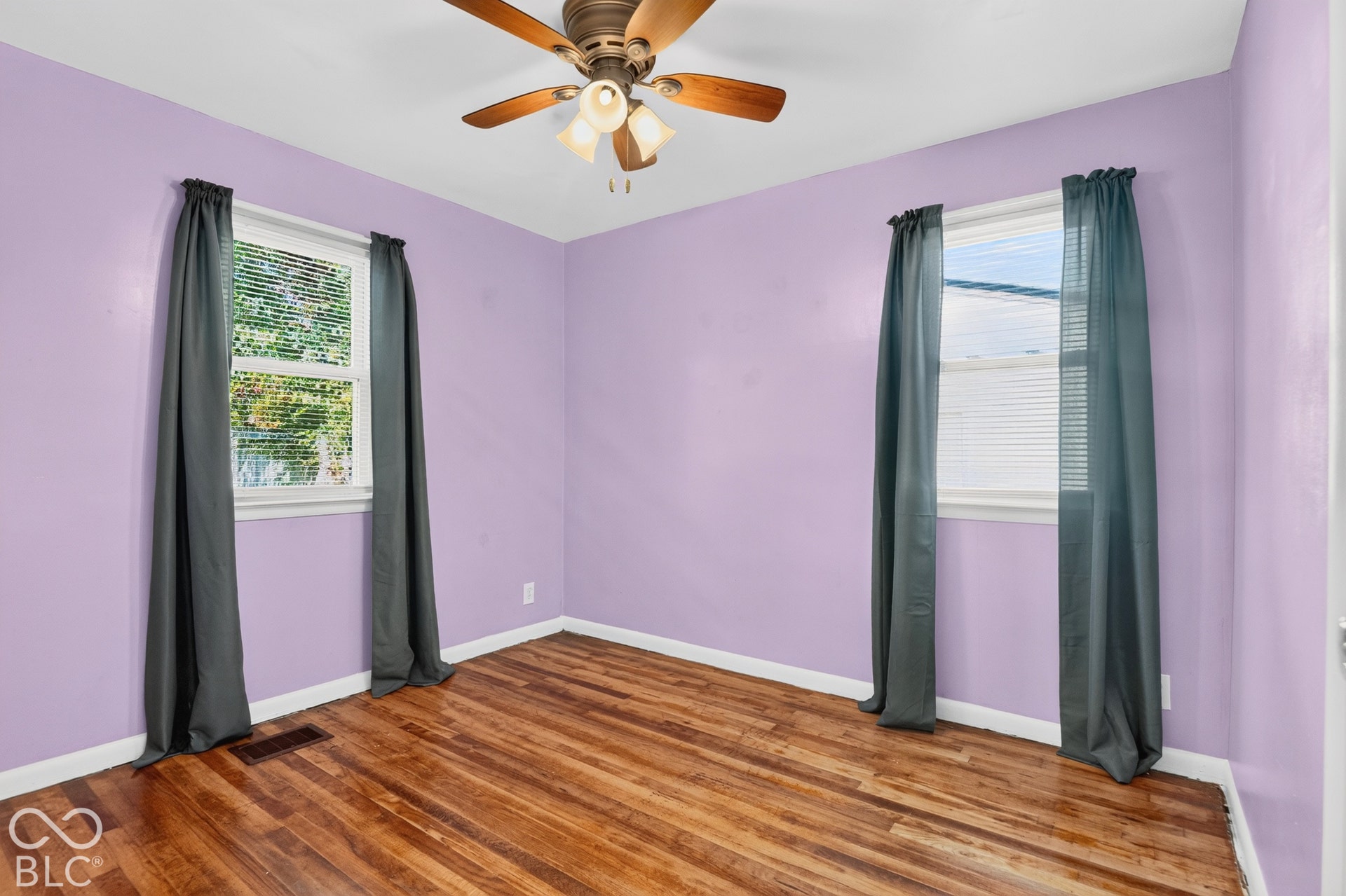 2706 13th Street, Columbus, IN 47201 Wood-finish flooring, two dual-pane windows, and a ceiling-mounted light fixture with a fan