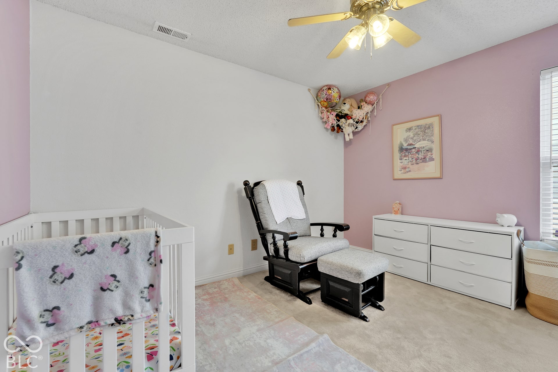 Neutral-toned carpeting paired with light-colored walls and one accent wall