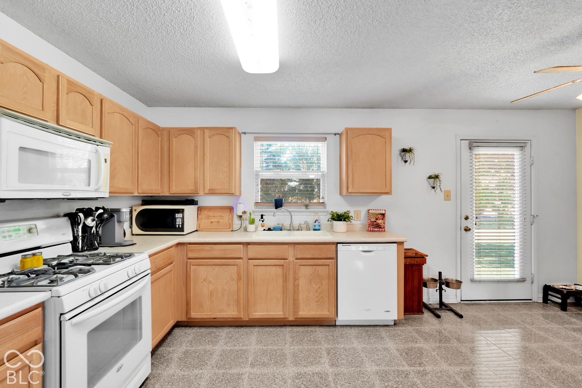 Kitchen featuring wood-finish cabinetry, a gas range, a built-in microwave, and a dishwasher