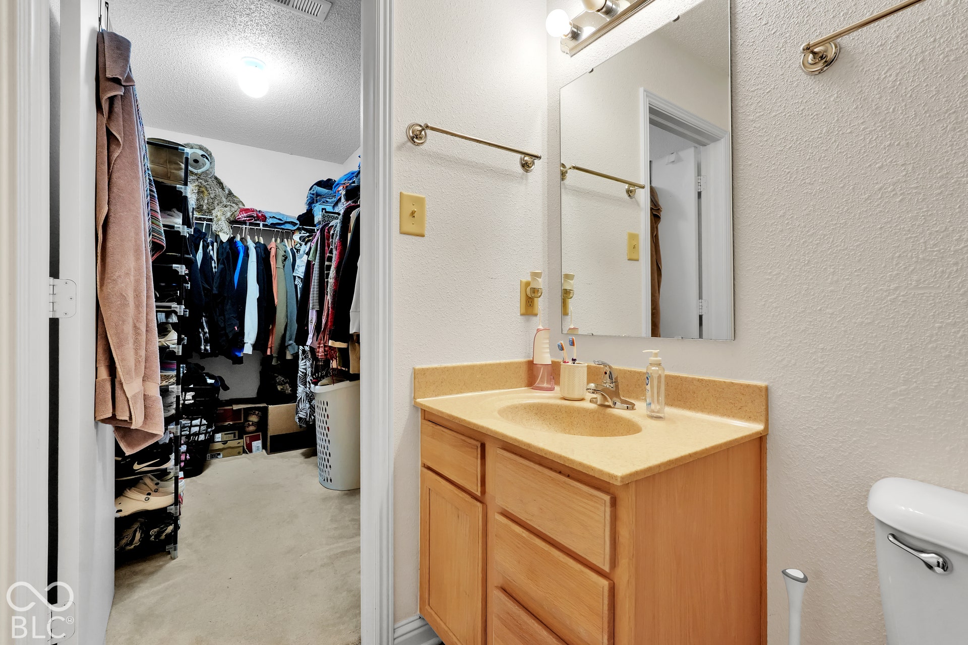 Vanity with an integrated sink and light wood-finish cabinetry