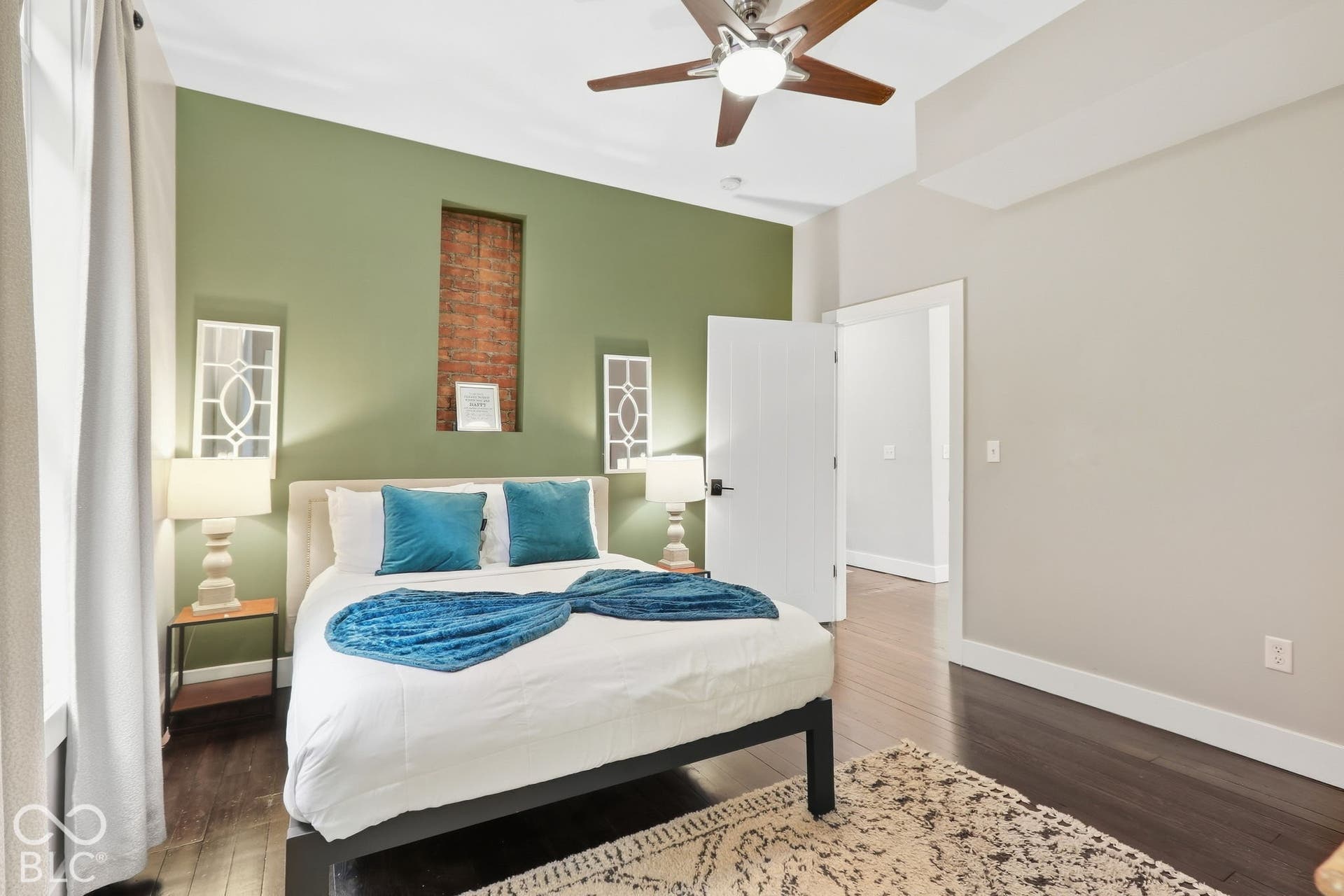 Dark wood-finish flooring with a multi-blade ceiling fan