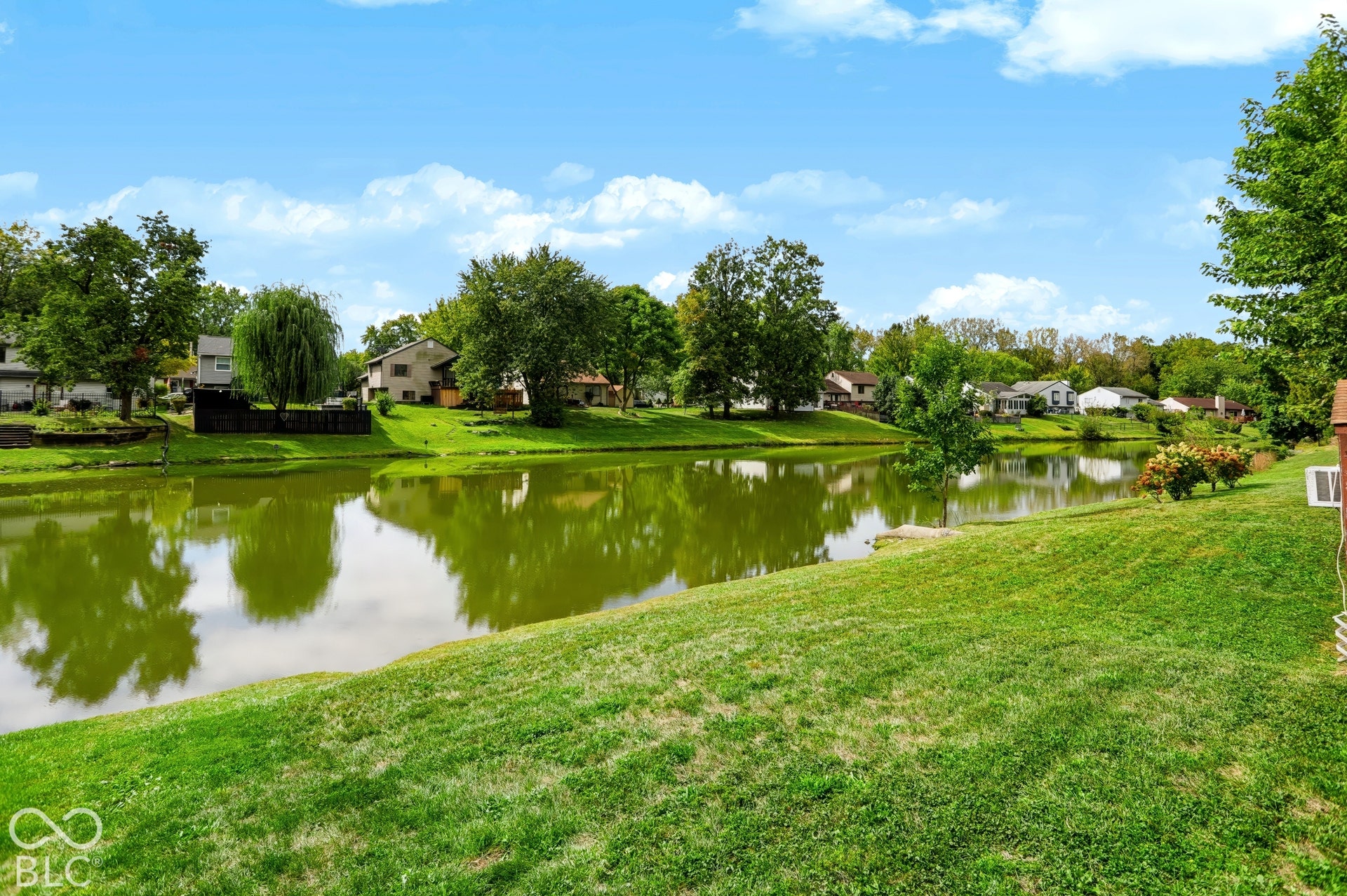 5907 Timber Lake Boulevard, Indianapolis, IN 46237 Expansive grassy area with a waterway and mature trees