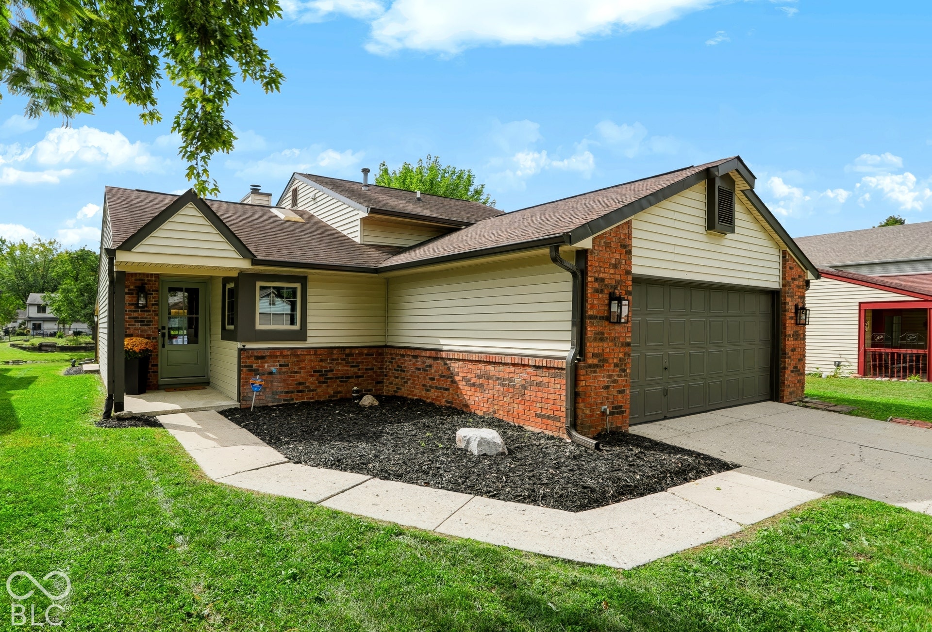 5907 Timber Lake Boulevard, Indianapolis, IN 46237 Brick and siding exterior, attached two-car garage, covered entry, and concrete walkway
