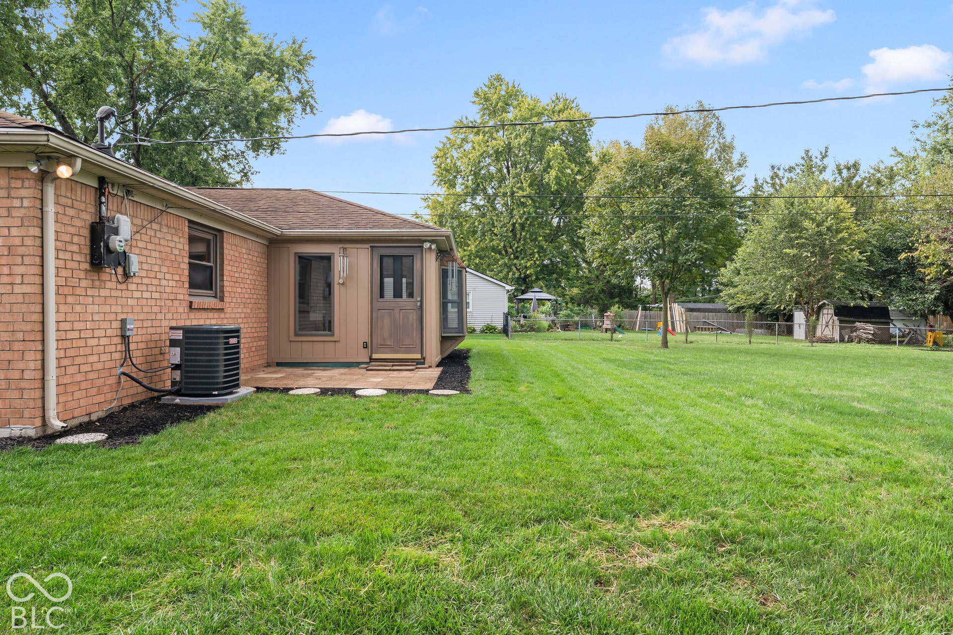 Expansive rear yard with mature trees