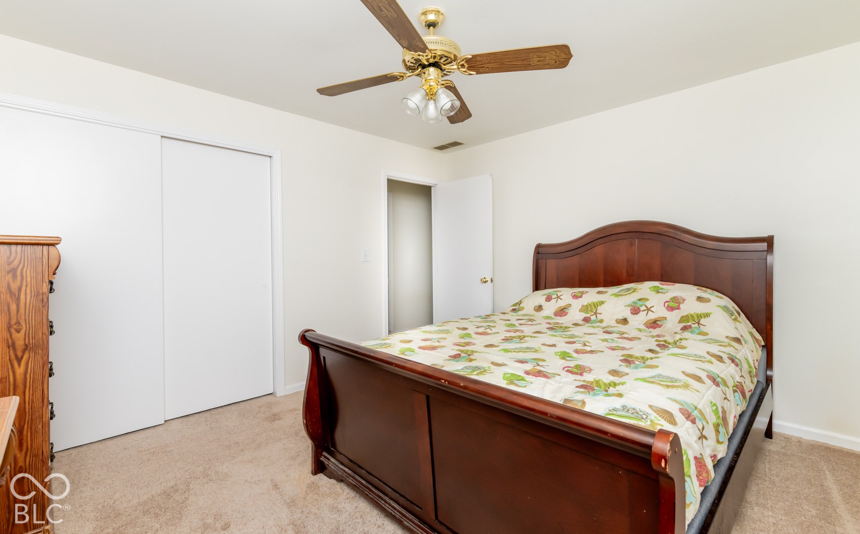 Carpeted flooring with a ceiling fan