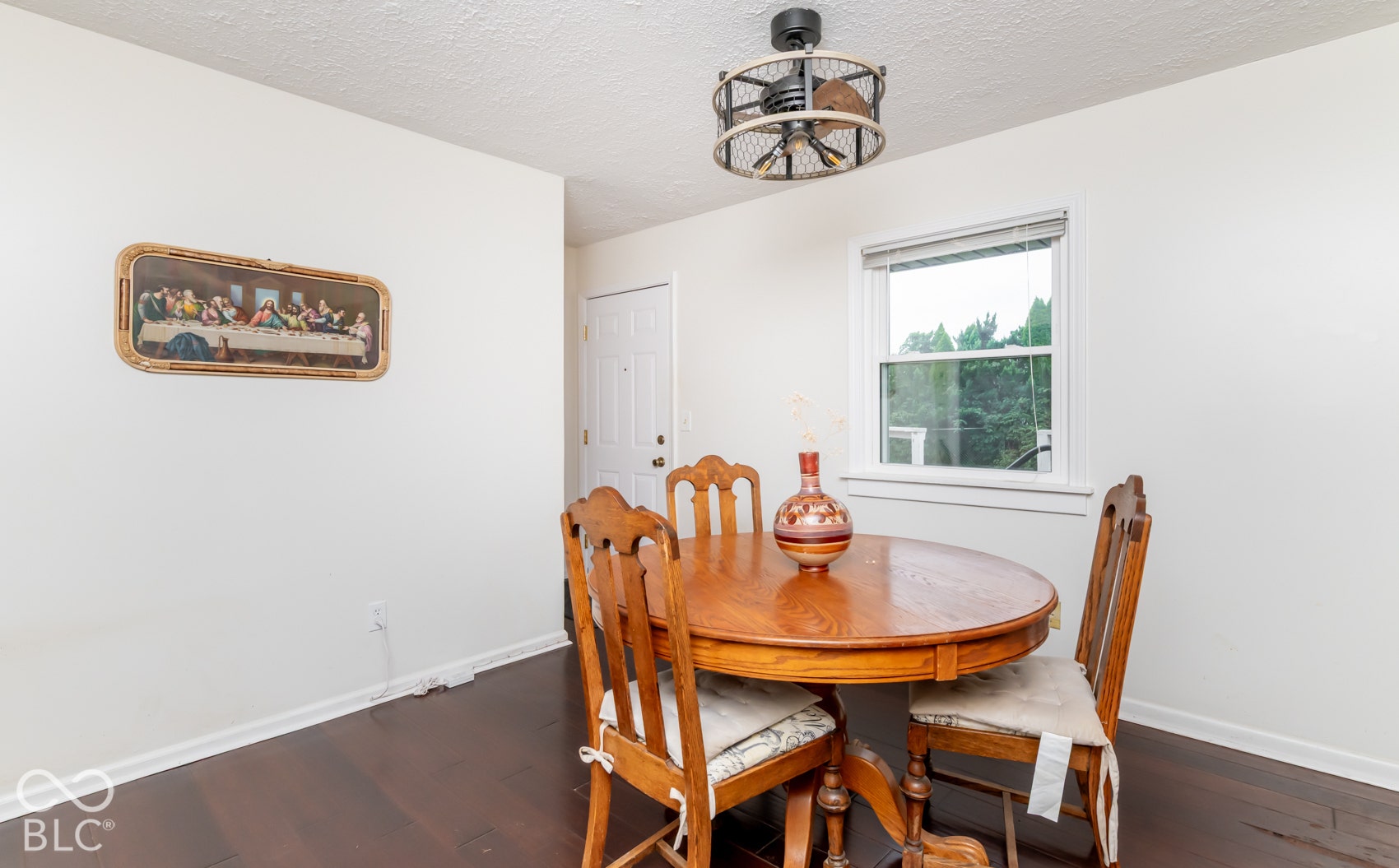 Dark wood-finish flooring with white baseboards