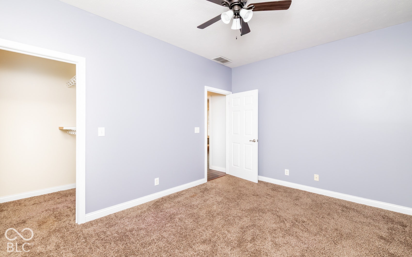 Neutral-toned walls complement plush carpeting