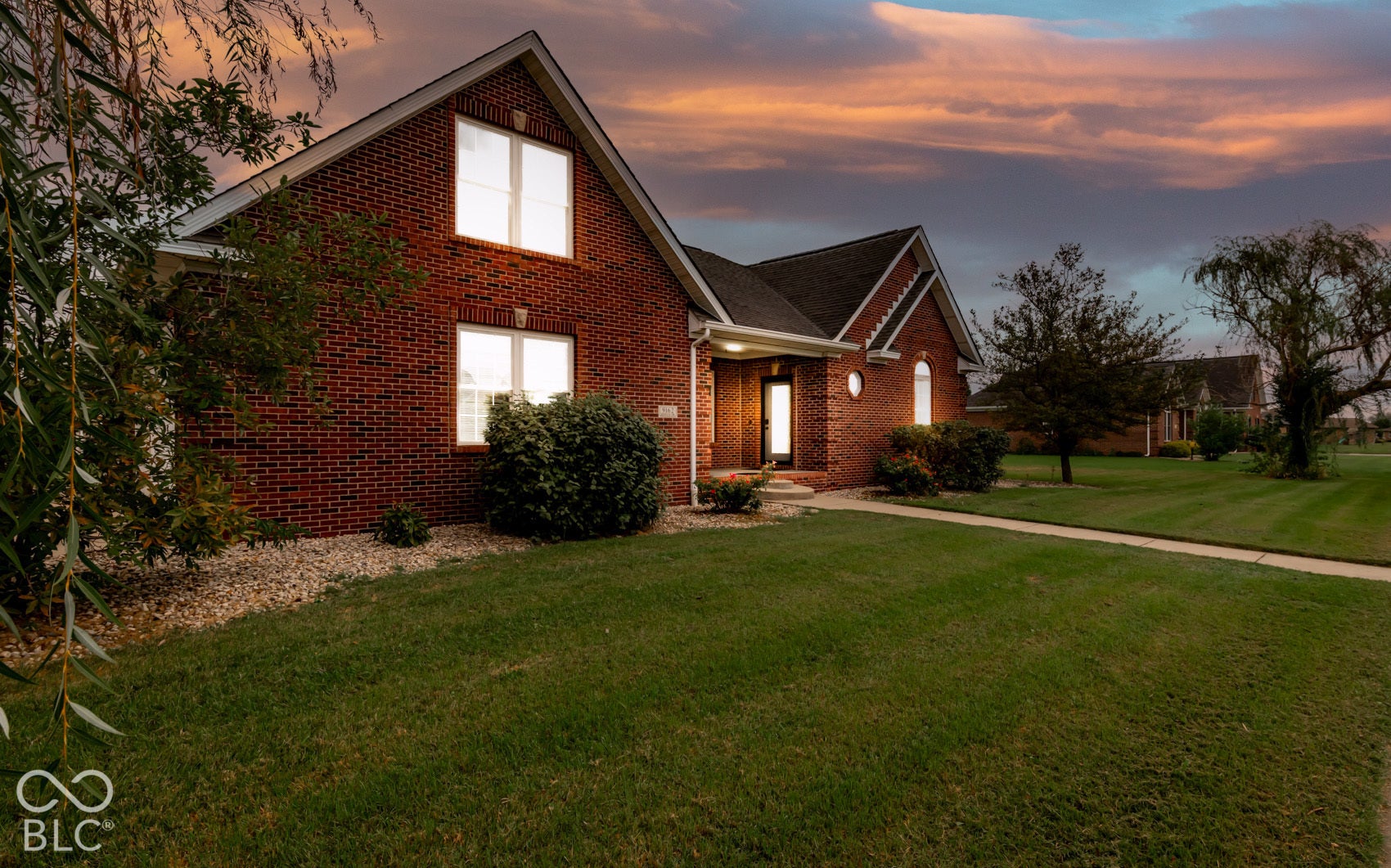 Brick exterior residence with an arched entry