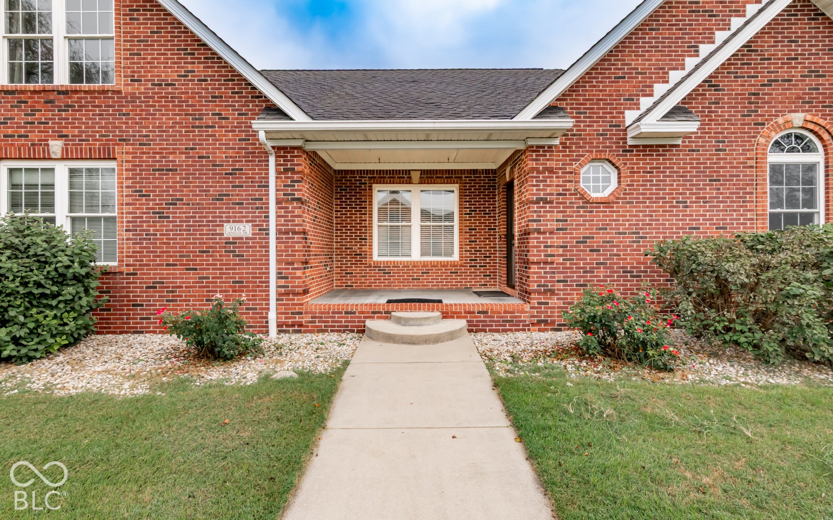 Brick exterior featuring multiple window styles
