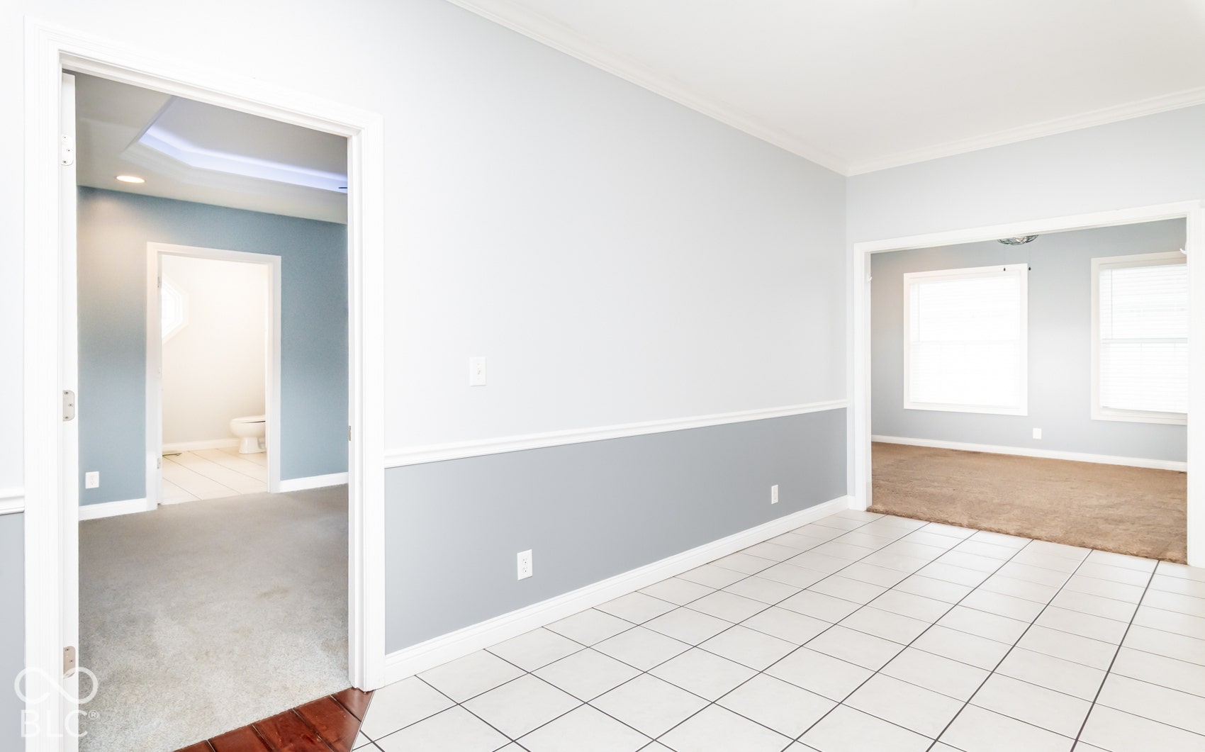 Neutral-toned walls with chair rail molding