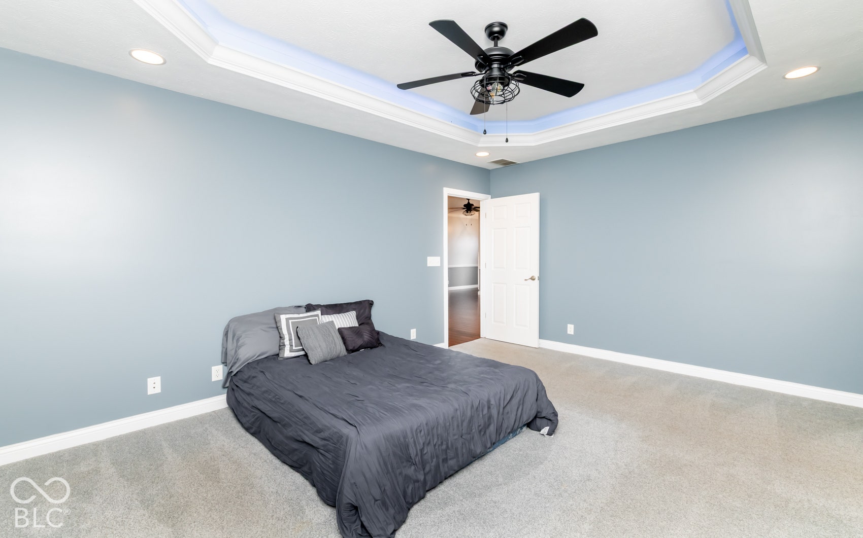 Tray ceiling with accent lighting, recessed lighting, and a ceiling fan