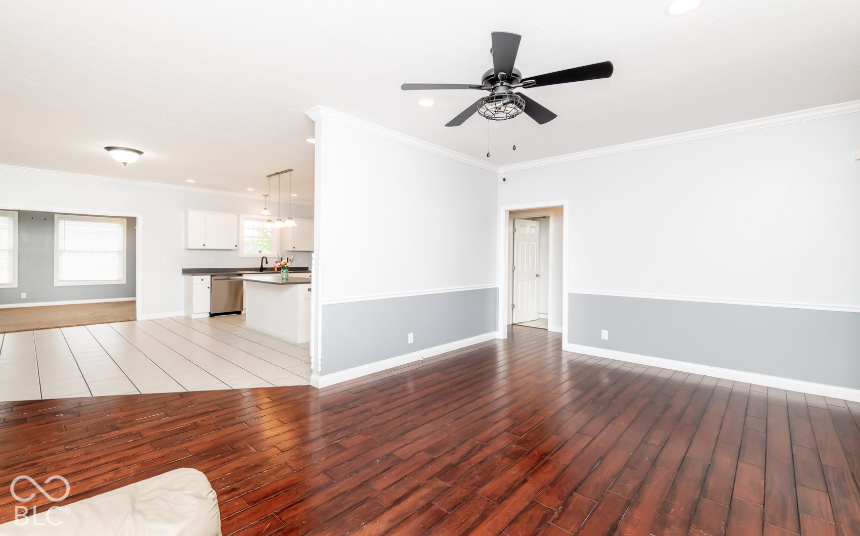 Hardwood flooring, two-tone wall paint, crown molding, ceiling fan, recessed lighting