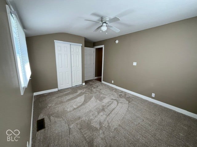 415 W Main, Greensburg, IN 47240 Bedroom 2 with Vaulted ceiling, ceiling fan, neutral wall paint, white trim, and carpeting