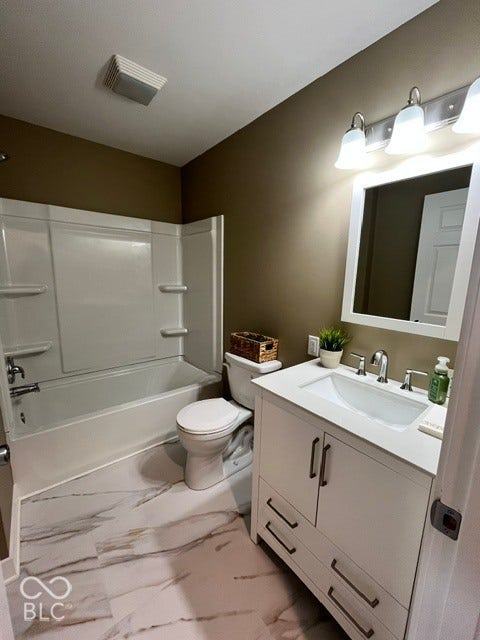 415 W Main, Greensburg, IN 47240 White vanity with brushed nickel hardware, integrated sink, and wall-mounted light fixture