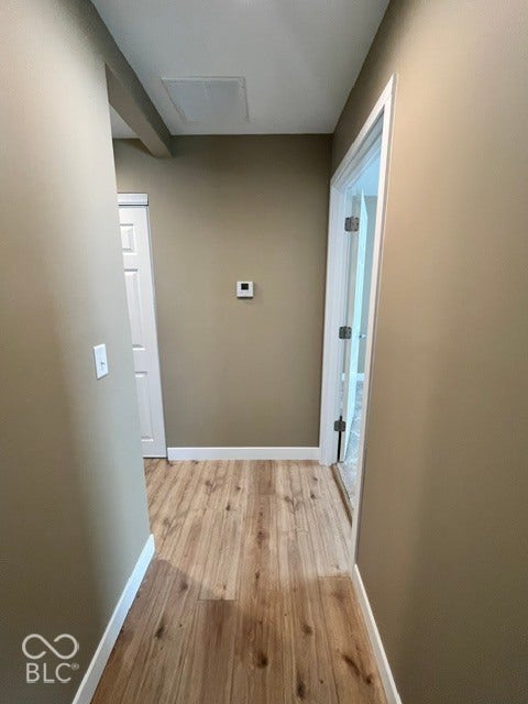 415 W Main, Greensburg, IN 47240 Laminate flooring with white trim, neutral-toned walls, and white interior doors