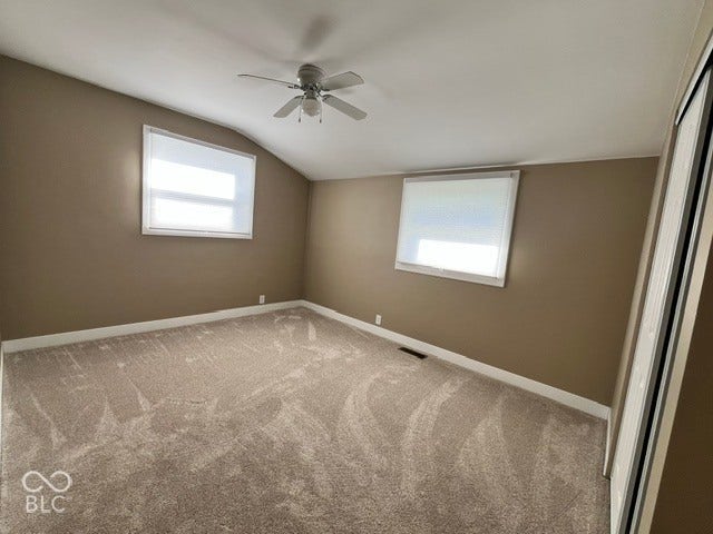 415 W Main, Greensburg, IN 47240 Bedroom 2 with Vaulted ceiling and ceiling fan, windows, and plush carpet flooring