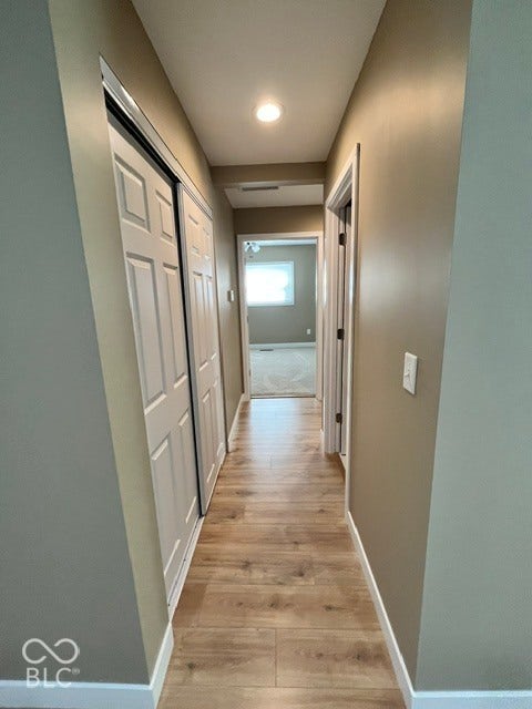 415 W Main, Greensburg, IN 47240 Recessed ceiling lighting illuminates a hallway with laminate wood-finish flooring and neutral wall tones