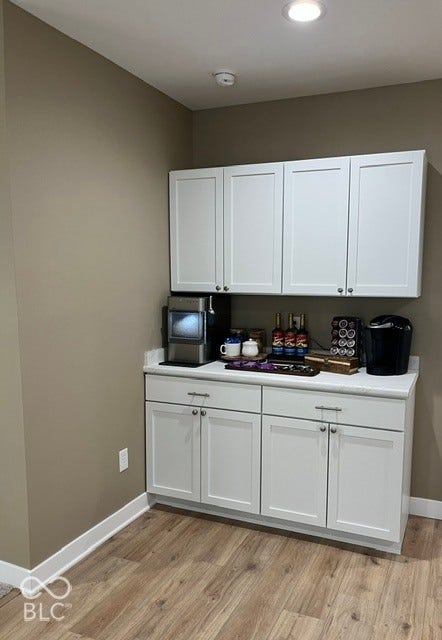 415 W Main, Greensburg, IN 47240 Coffee Bar with White shaker-style cabinetry featuring chrome hardware, light-toned countertop, laminate flooring, and recessed ceiling lighting
