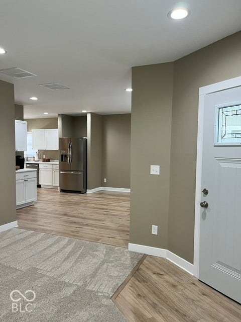 415 W Main, Greensburg, IN 47240 Looking into the Dining Room, Recessed lighting throughout, and a white entry door with decorative glass inlay