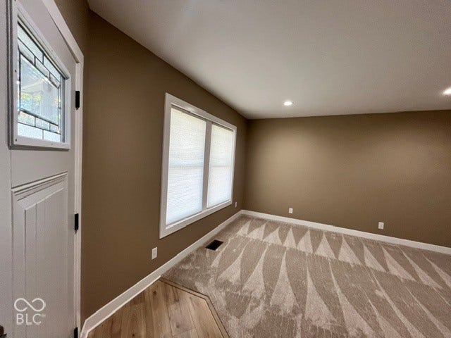 415 W Main, Greensburg, IN 47240 Entry door with decorative glass insert, recessed lighting, large window with blinds, and carpeting