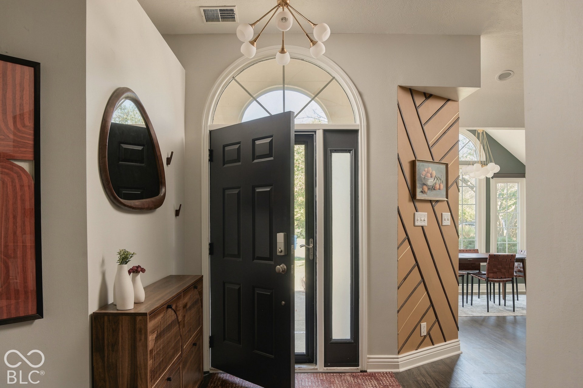 Arched transom window above a paneled front door with sidelights