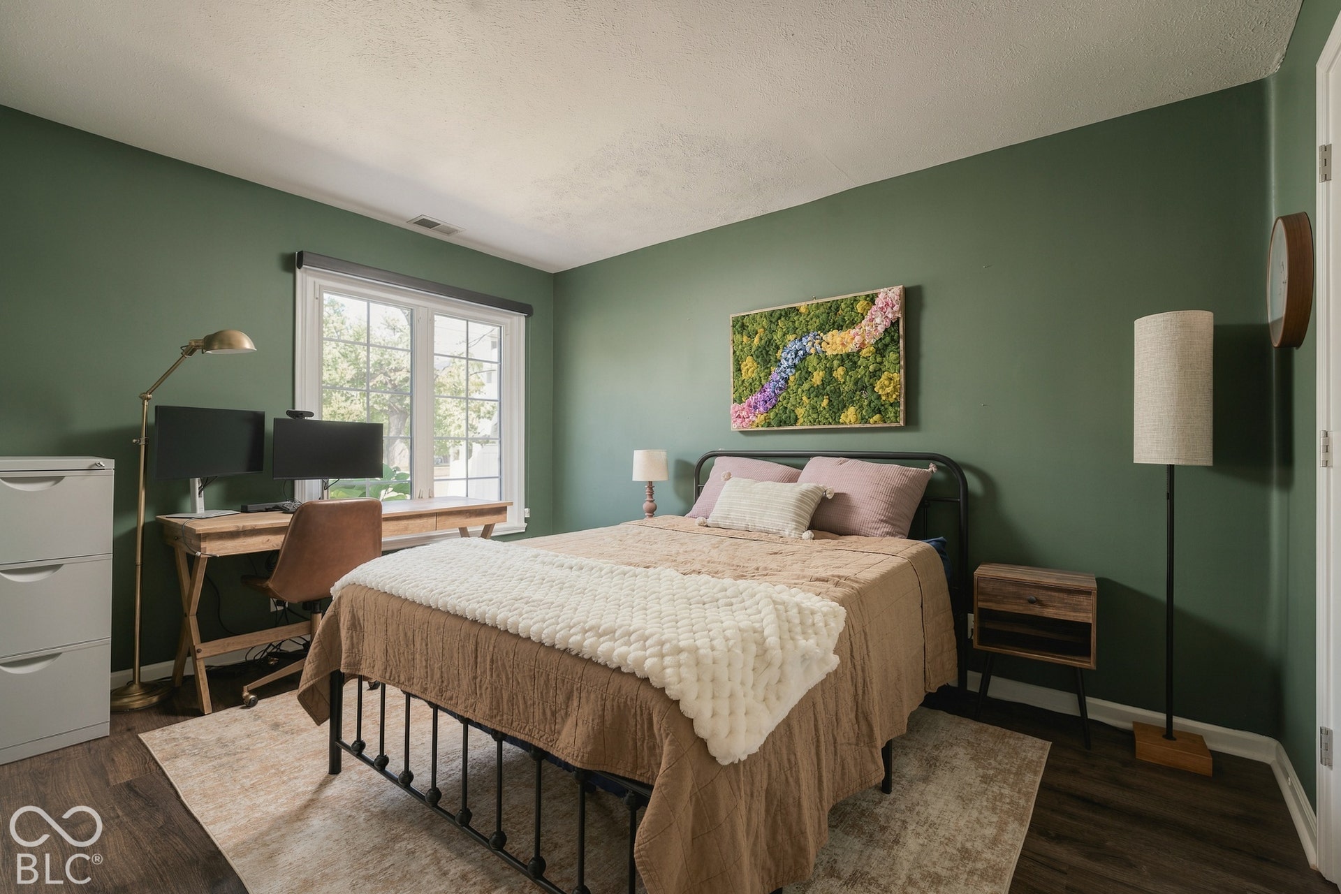 Wood-finish flooring, ample natural light from a multi-pane window, and a built-in closet with a white door