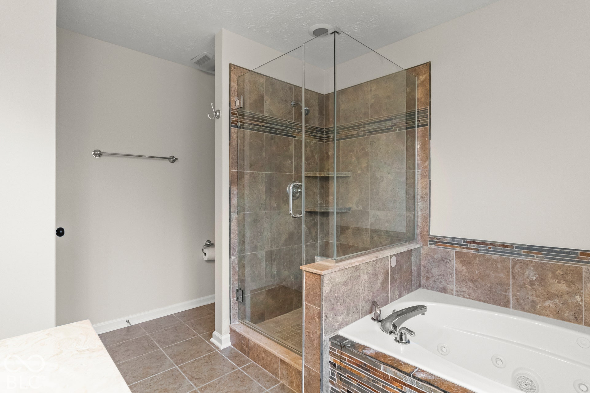 Tile-surround soaking tub with a deck-mounted faucet