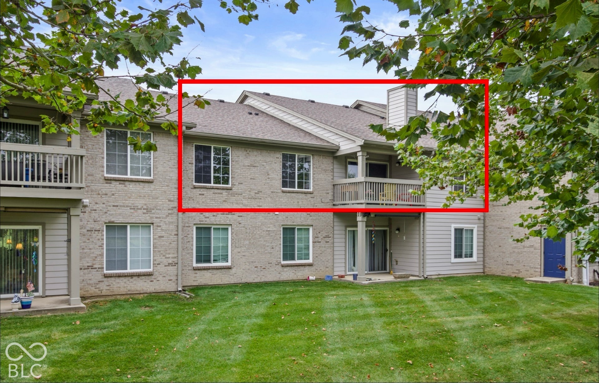 Brick and siding exterior with multiple windows and balconies