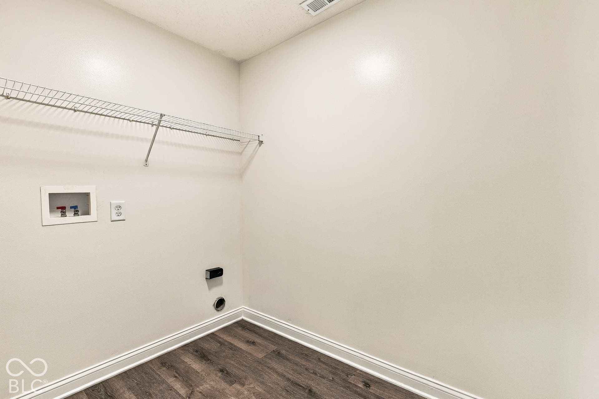 Built-in wire shelving, utility hookups, wood-finish flooring