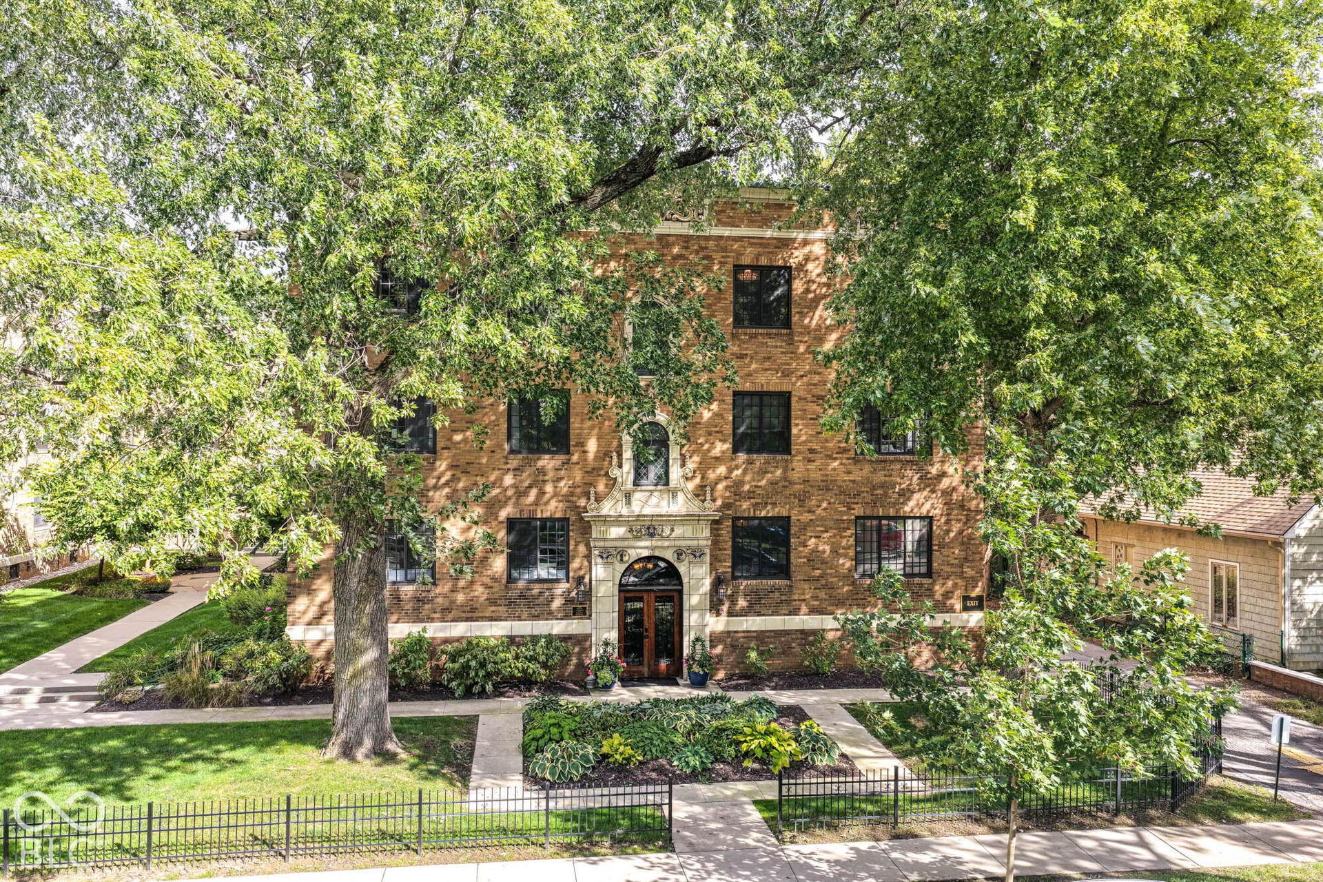 Brick exterior facade with decorative stone entryway
