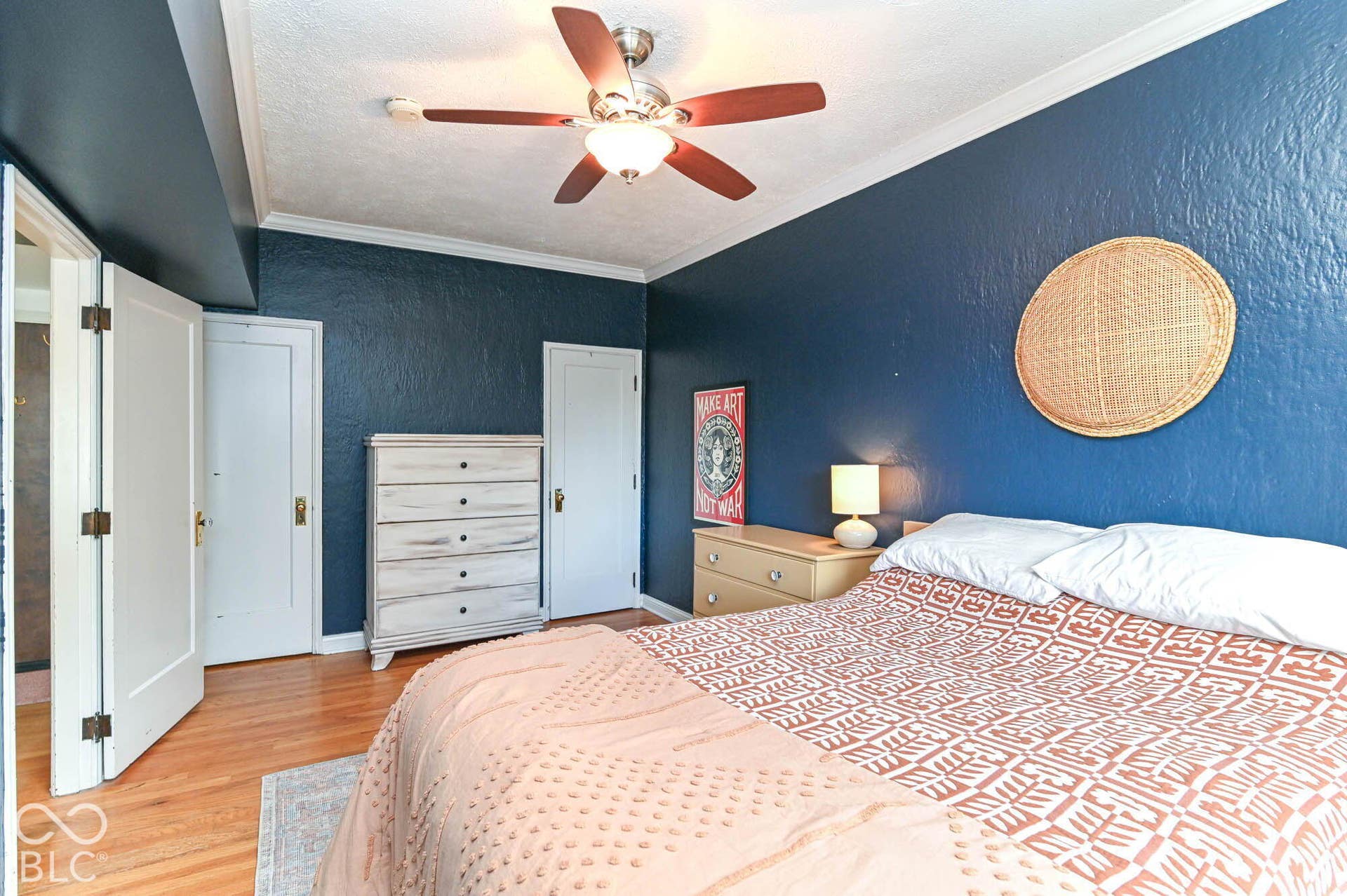 Wood-finish flooring with white trim and crown molding