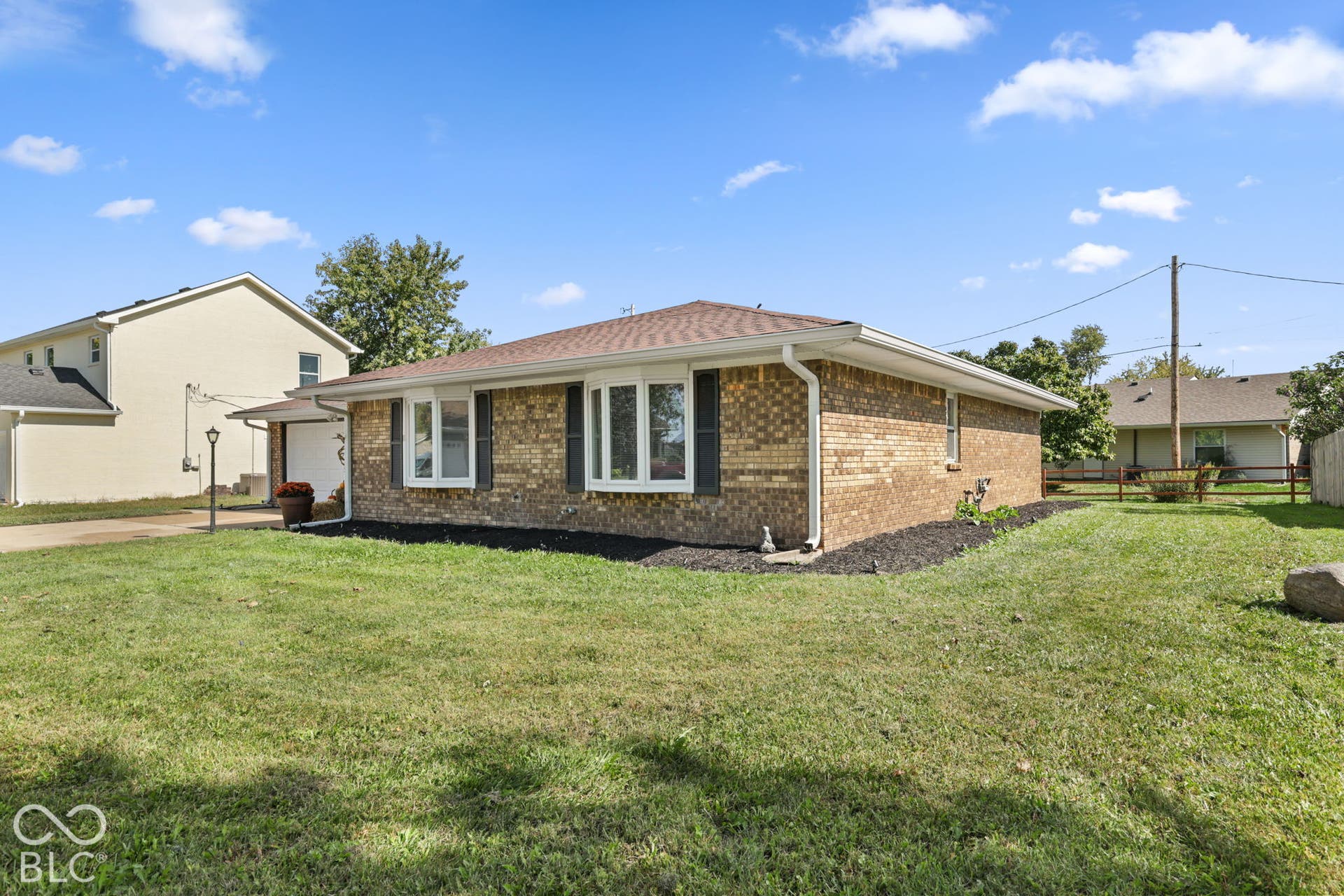 Brick exterior with a brown shingle roof