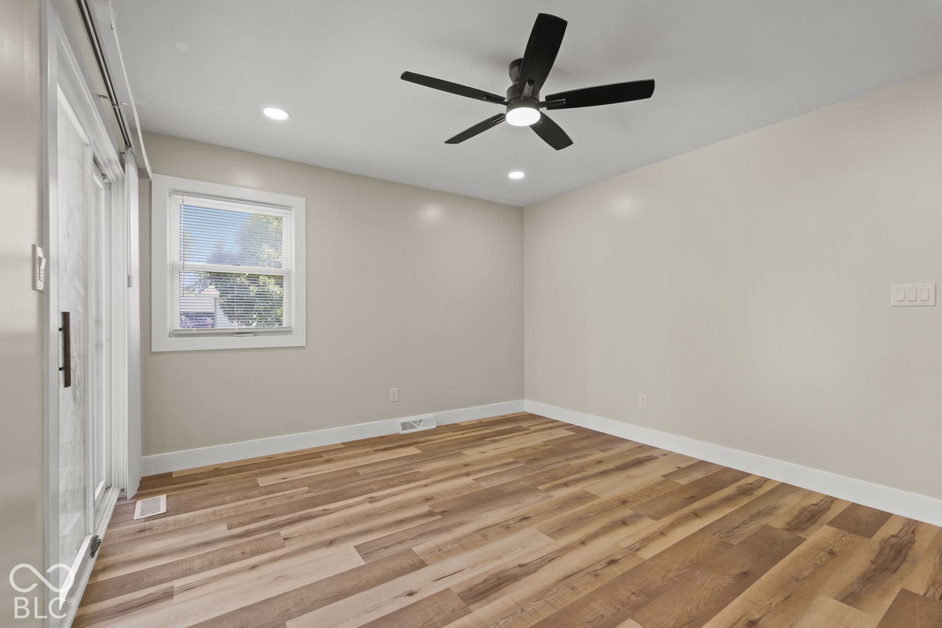 Wood-finish flooring, recessed lighting, and a ceiling fan with integrated lighting