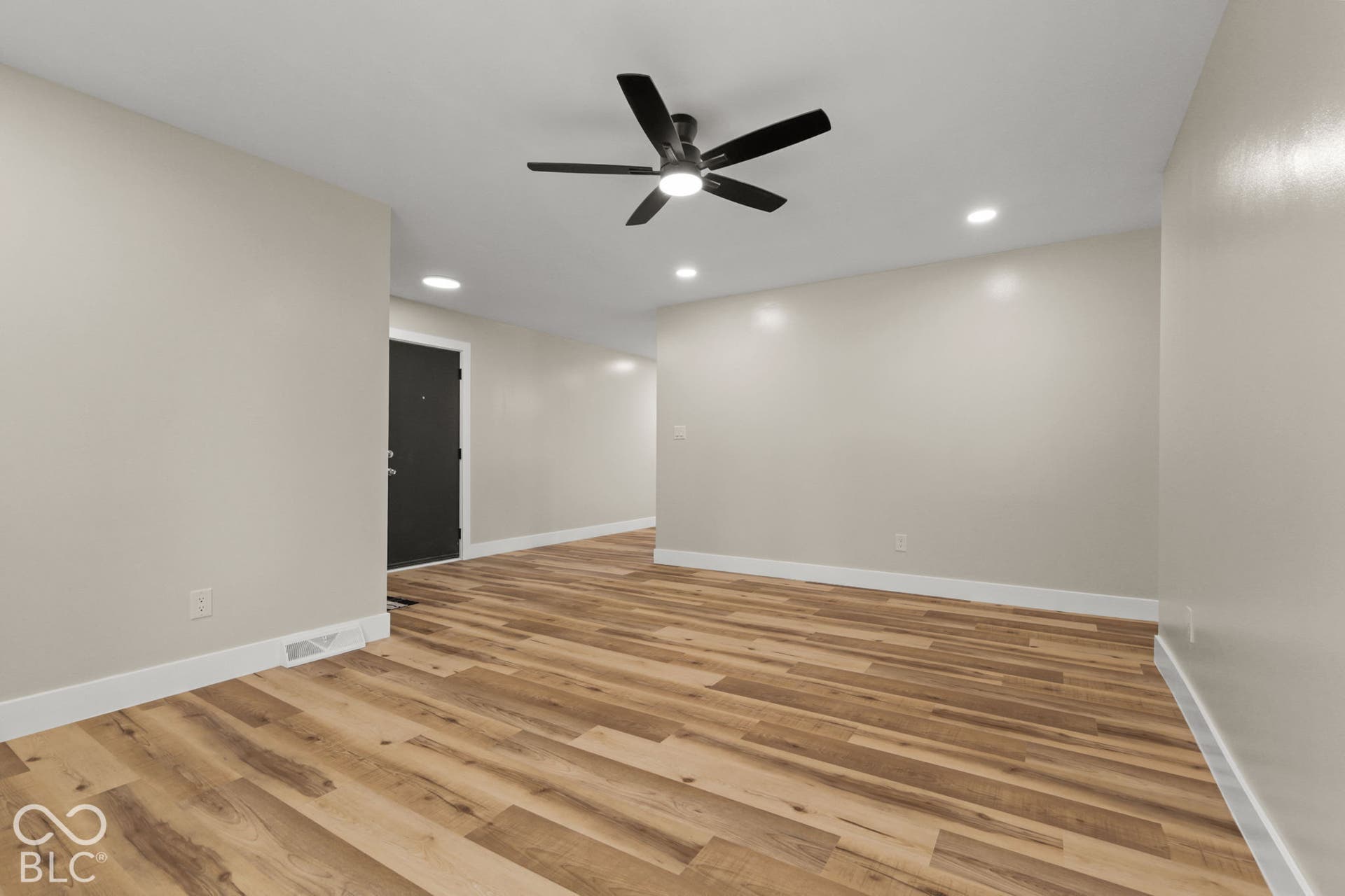 Recessed lighting, wood-finish flooring, and a contemporary ceiling fan with integrated lighting