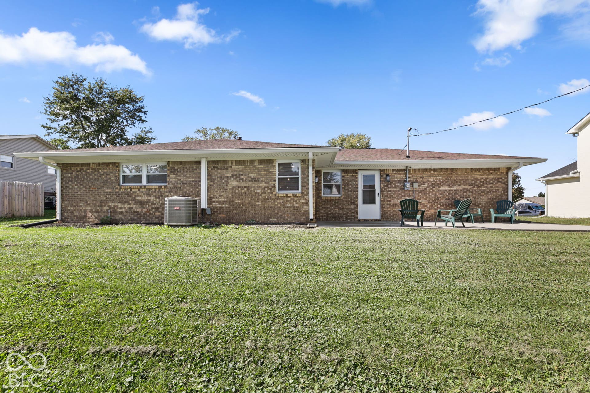 Brick exterior, covered patio, concrete patio surface, single-pane windows, central air conditioning unit