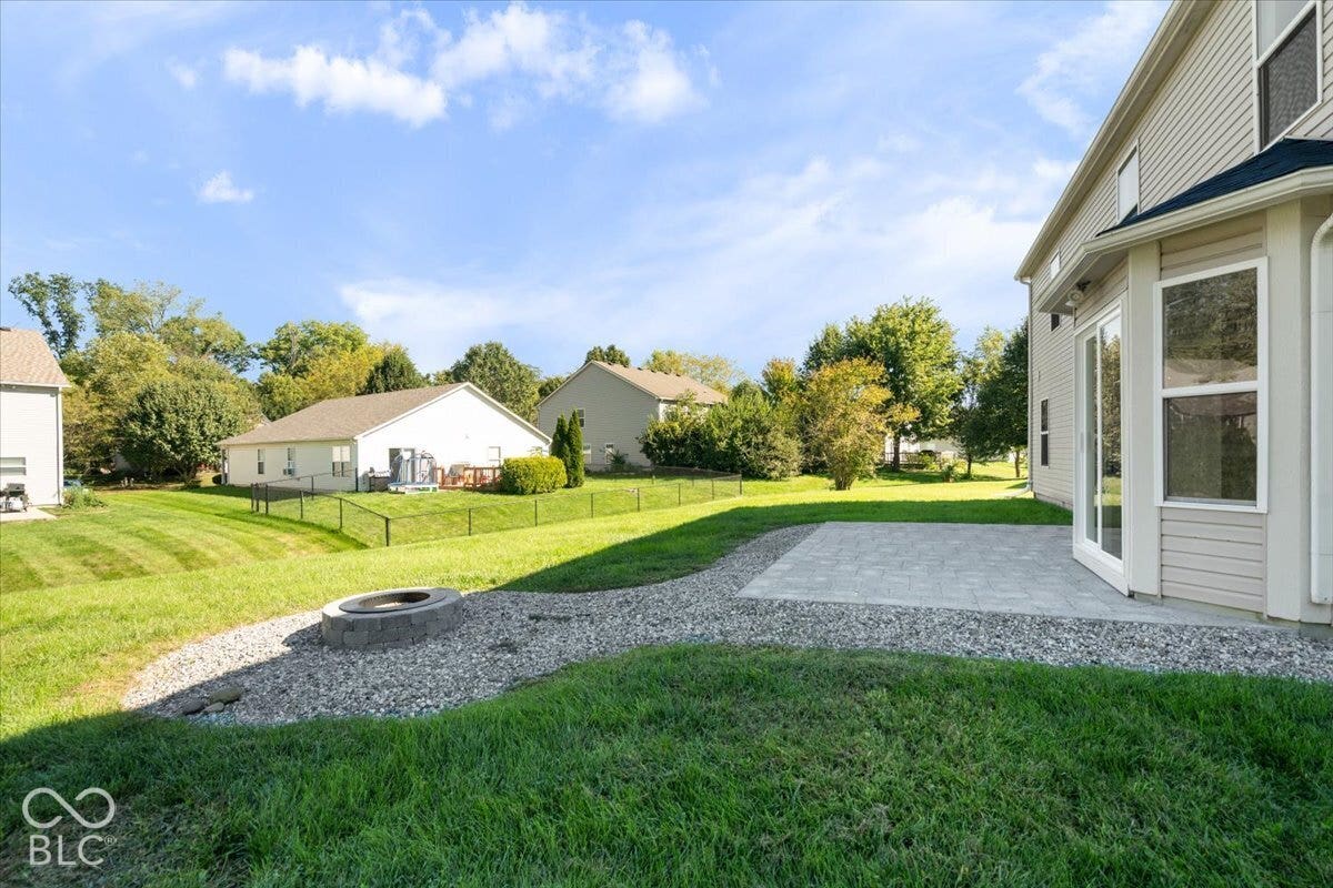 11780 Copper Mines Way, Fishers, IN 46038 Expansive yard featuring a paver patio, integrated fire pit, and gravel landscaping
