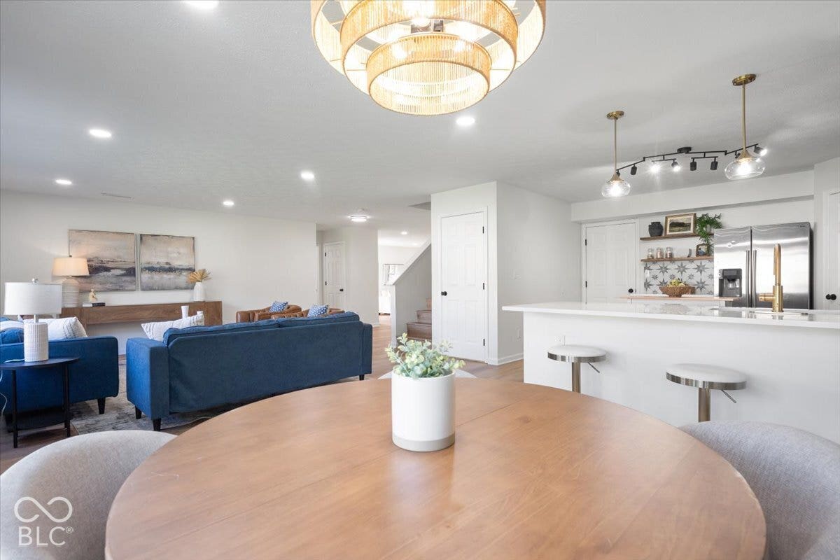 11780 Copper Mines Way, Fishers, IN 46038 Open-concept living space with recessed lighting, wood-finish flooring, and a kitchen island with seating
