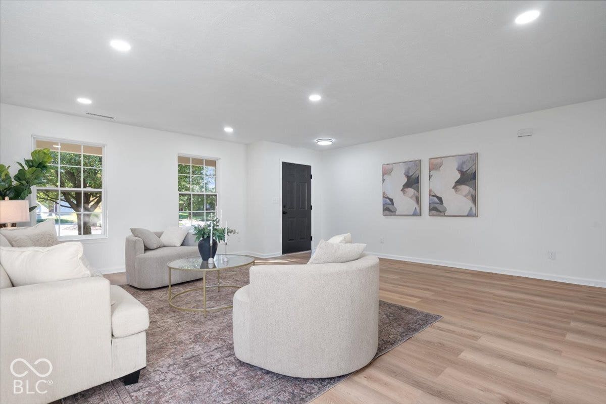 11780 Copper Mines Way, Fishers, IN 46038 Spacious living area featuring light wood-finish flooring, recessed lighting, and a dark paneled entry door