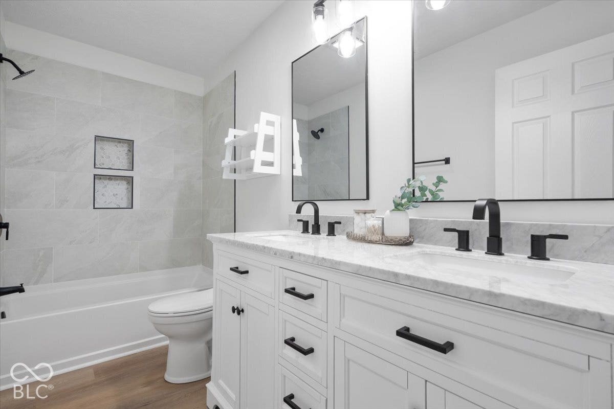 11780 Copper Mines Way, Fishers, IN 46038 Dual vanity with white cabinetry, matte black hardware, and a light-toned countertop