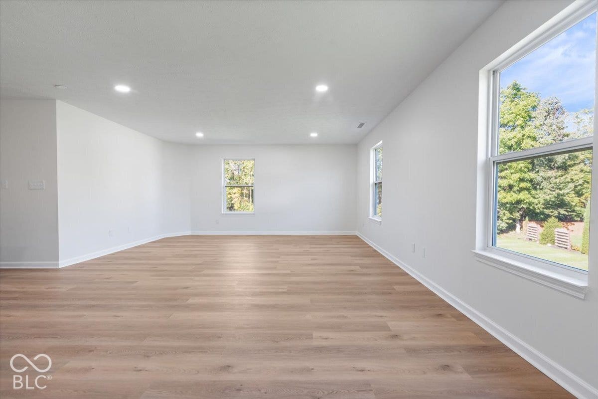11780 Copper Mines Way, Fishers, IN 46038 Recessed lighting, wood-finish flooring, white walls, multiple windows, and ample natural light