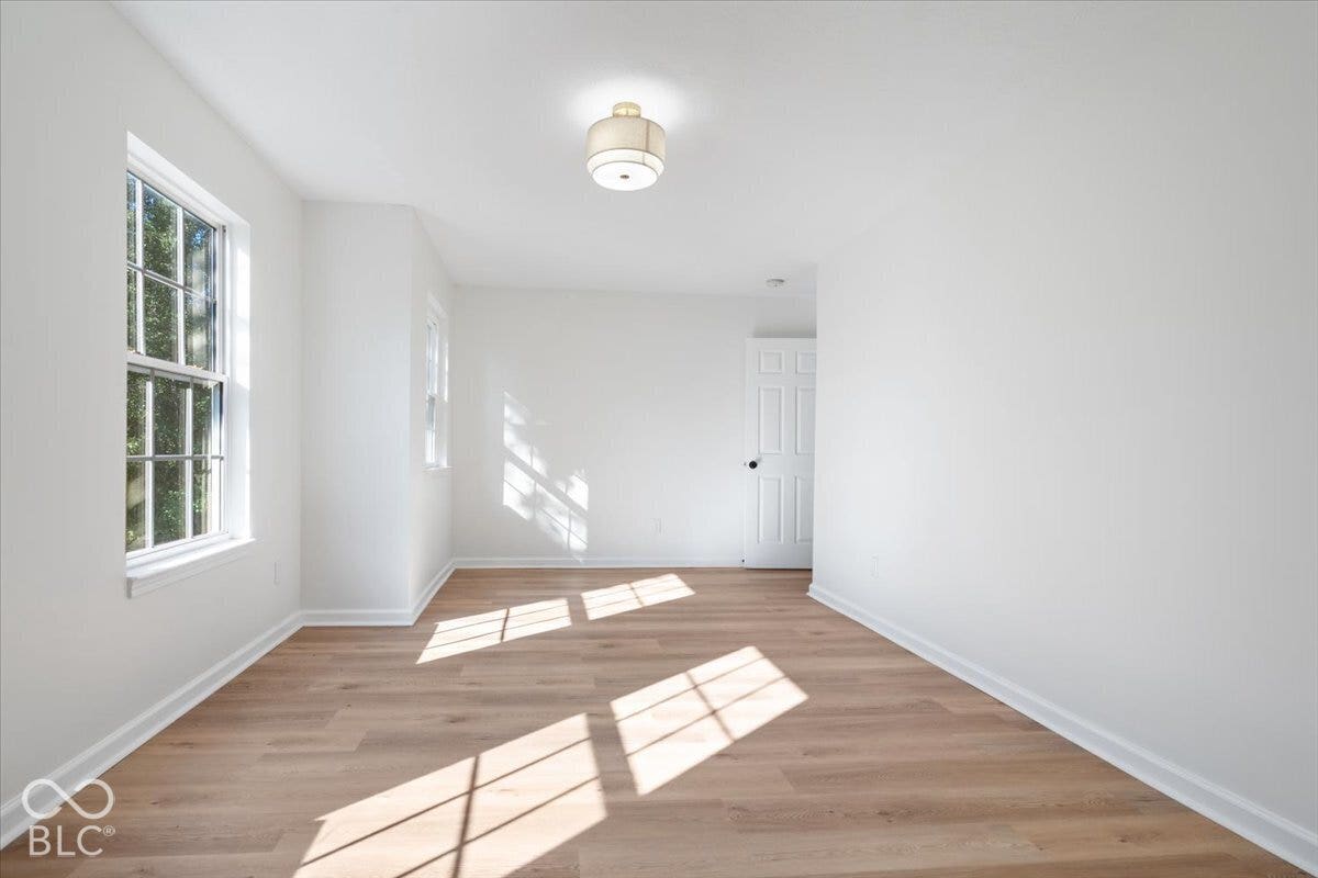 11780 Copper Mines Way, Fishers, IN 46038 Wood-finish flooring, white painted walls, a flush-mount ceiling fixture, and a paneled door