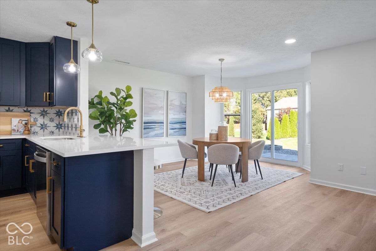 11780 Copper Mines Way, Fishers, IN 46038 Kitchen with navy cabinetry, light-toned wood-finish flooring, and a white countertop