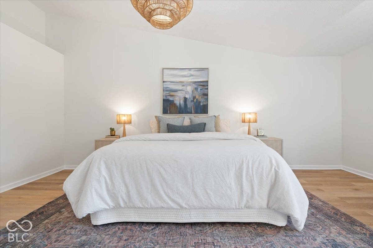 11780 Copper Mines Way, Fishers, IN 46038 Vaulted ceiling, wood-finish flooring, recessed wall detail, white wall finishes, and overhead fixture