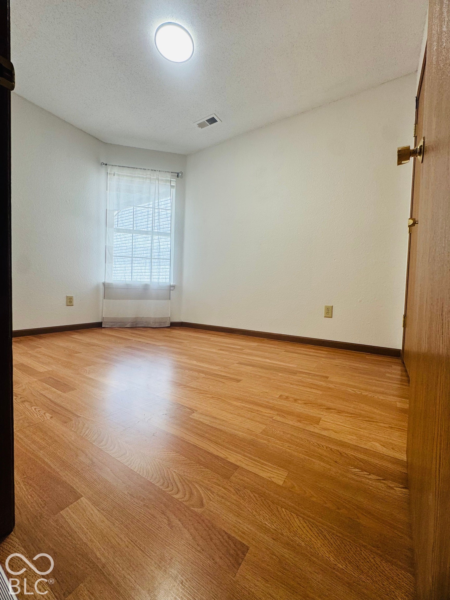 Wood-finish flooring with white walls