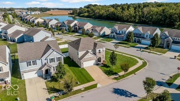 Suburban neighborhood featuring varied architectural styles and a tranquil water body